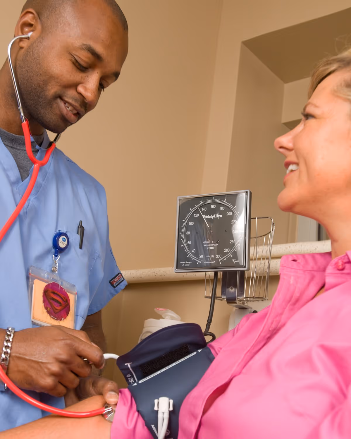 A community nurse and a participant smiling together during a home visit