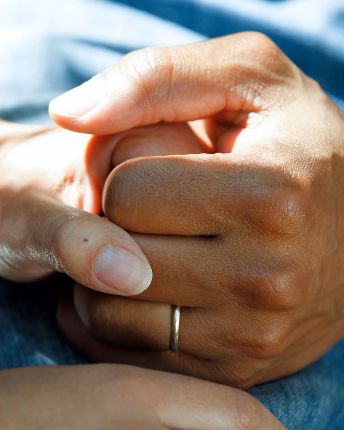 Two people holding hands in a gesture of warmth and reassurance