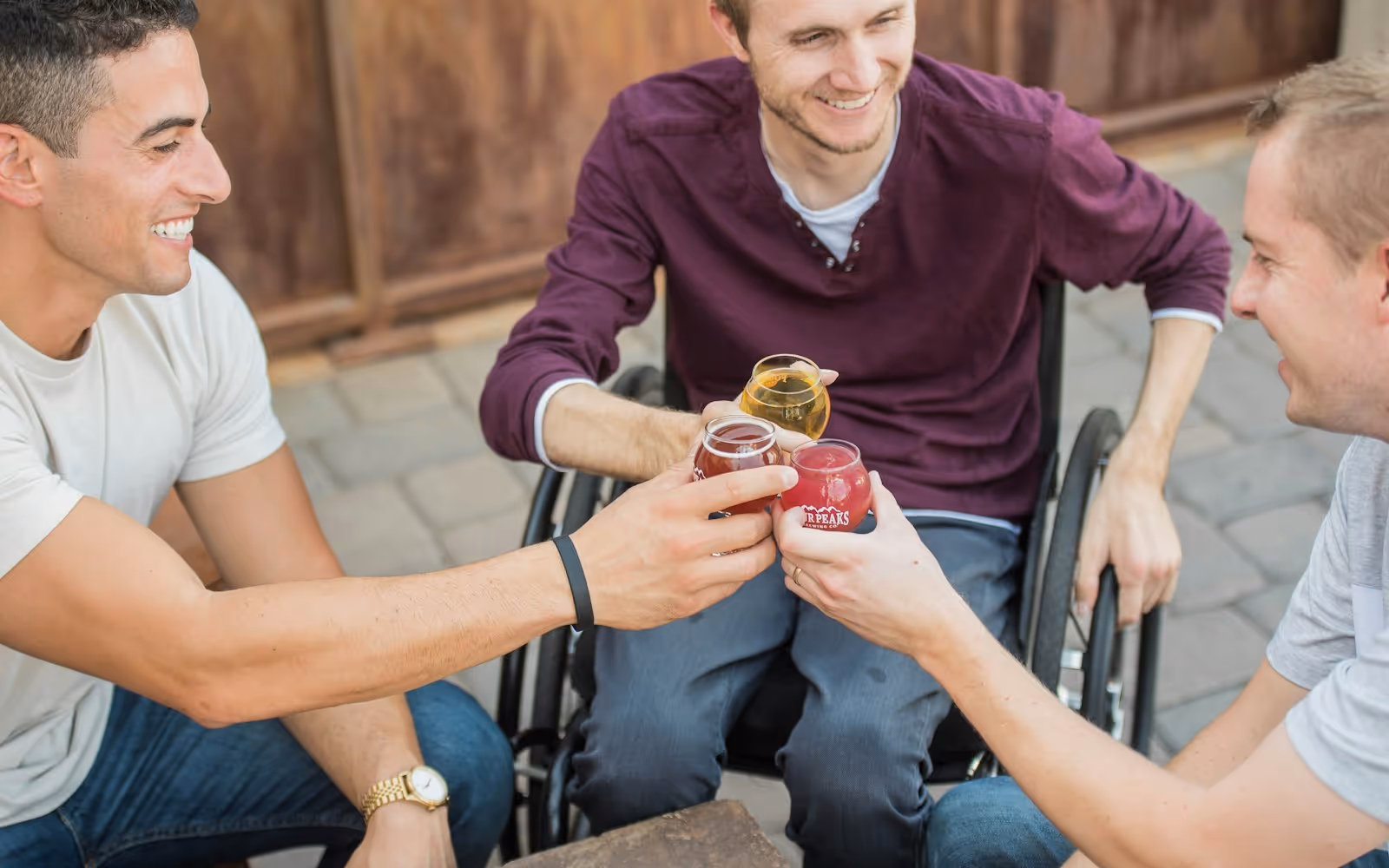 Friends sharing a relaxed moment together, one of them using a wheelchair