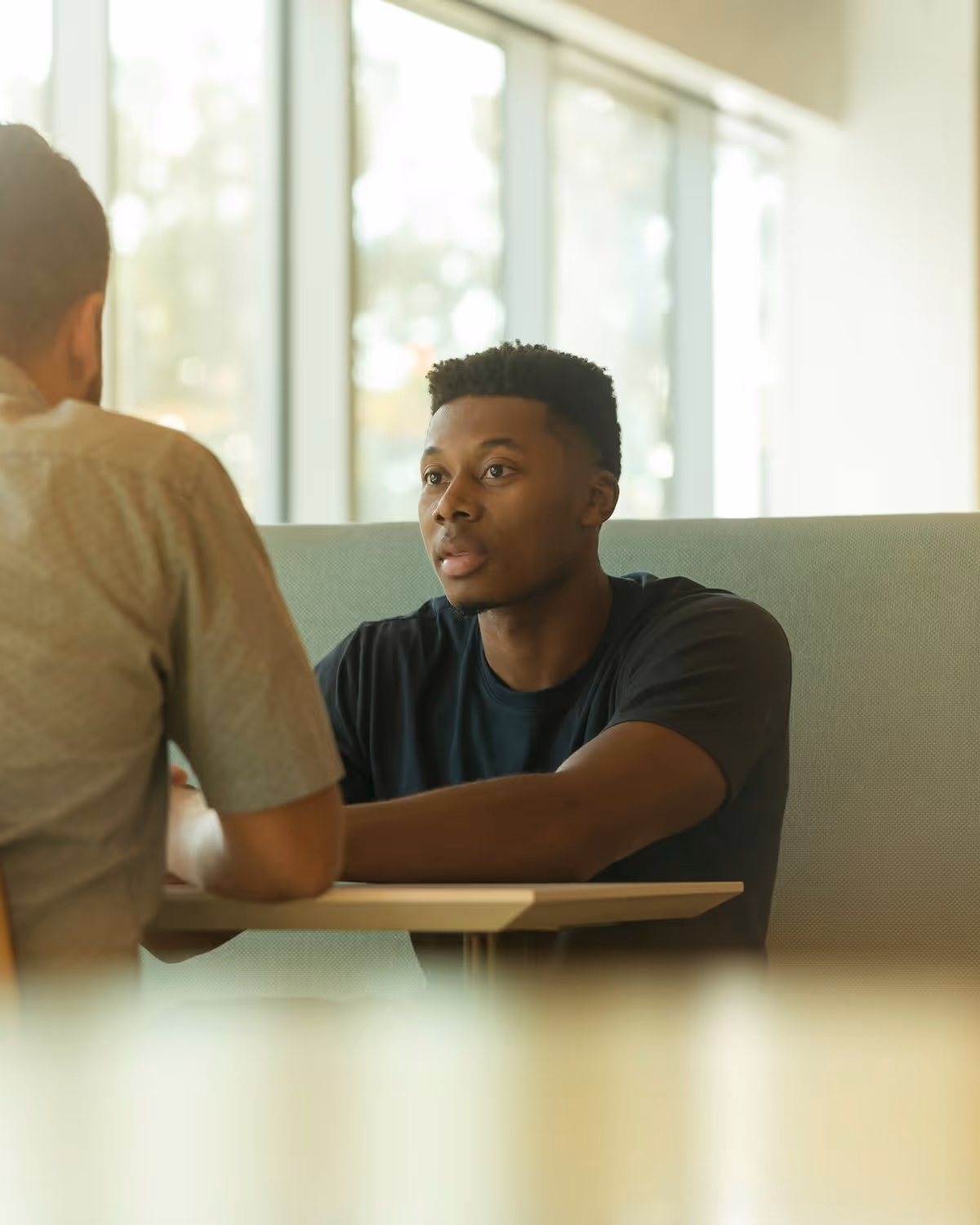 A practitioner and a participant talking together in a calm one-to-one session