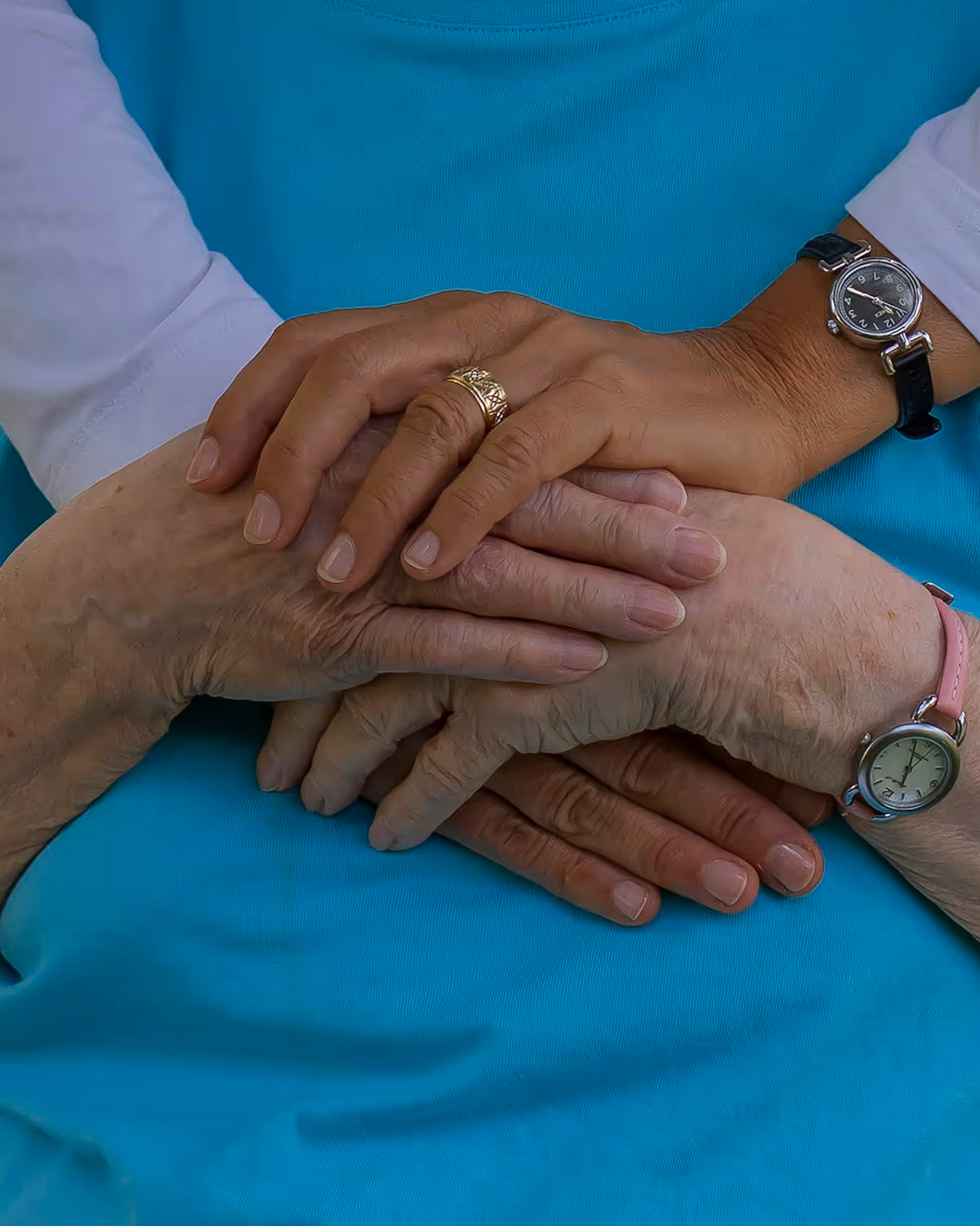 A support worker offering a reassuring hand to the person they support